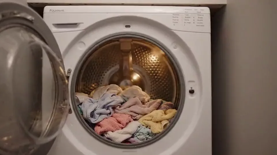 Front-load dryer with the door open and laundry inside